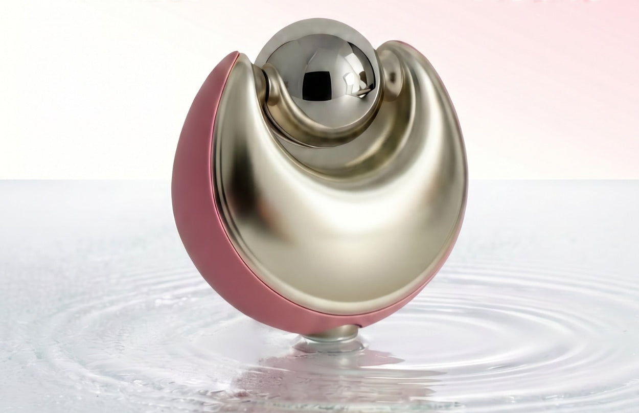 A skincare puffing device with a metallic gold and pink design, standing on water ripples against a pink gradient background with text reading 'DEPUFF. REFRESH.